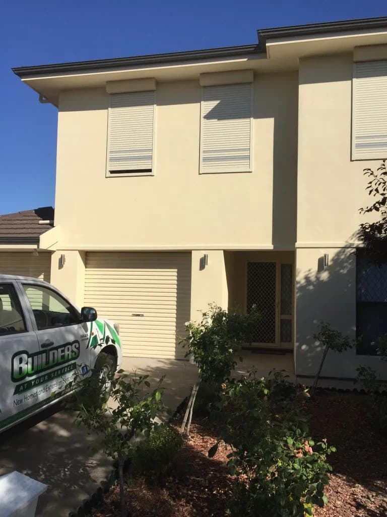 Builders At Your Service liveried work ute parked outside a two-storey home extension project