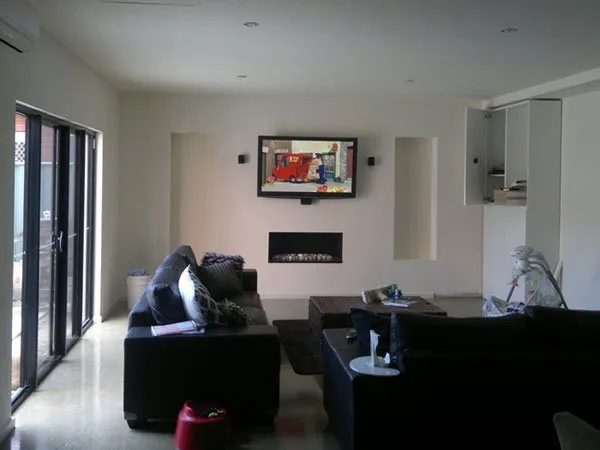 Family room extension with a wall-mounted TV, built-in cabinetry and a recessed gas fireplace